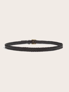 Detail of black woven leather belt featuring a classic polished gold buckle closure