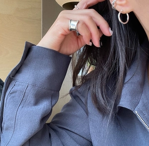 Detailed view of minimalist 925 silver earring and ring on model for a modern look