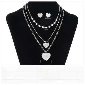 Detailed view of triple-layer stainless steel heart necklace and pearl stud earrings set
