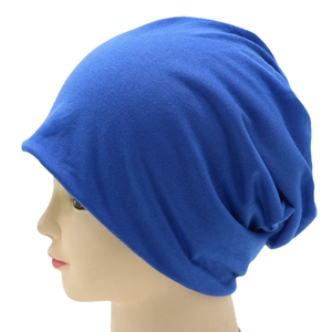 Side view of royal blue slouchy beanie showing knitted texture and relaxed fit style