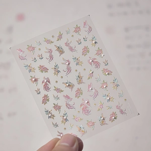 Detailed view of 3D embossed nail art stickers with phoenix and pearl flower patterns