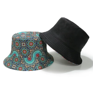Detail of bohemian geometric print bucket hat alongside a classic plain black cotton cap