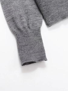 Detailed view of the ribbed cuffs and high-quality grey knit fabric of the cardigan