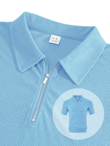 Close-up of blue men's waffle polo shirt featuring quarter zip and textured fabric detail
