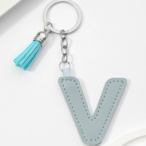 Close-up of light blue PU leather letter V keychain with matching tassel and silver ring