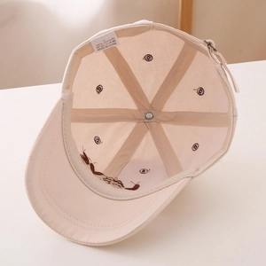 Detail view of cotton baseball cap interior featuring stitching and 100% cotton label
