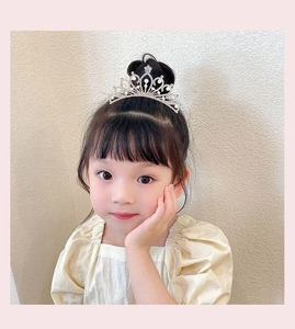 Close-up of sparkling crystal crown tiara hair comb worn by a little girl