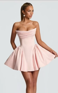 Close-up of pink strapless satin mini dress featuring pleated texture and ruffled hemline