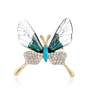 Macro shot of colorful dragonfly brooch featuring crystal rhinestones and gold base