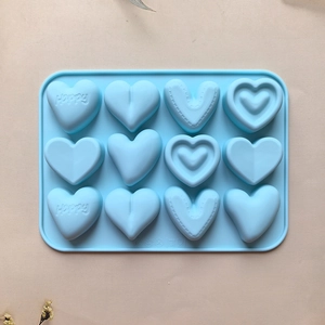 Close-up of light blue silicone heart mold with 12 cavities for DIY chocolate baking