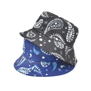Detail of stacked paisley and polka dot bucket hats in black and navy blue colors