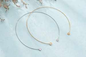 Detailed view of minimalist gold and silver chokers with hexagonal rhinestone studs