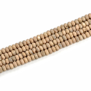 Macro detail of 5x8mm beige geode agate beads with natural matte texture for jewelry