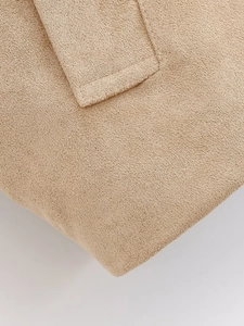 Close-up of khaki textured fabric showing pocket detail and premium stitching on jacket