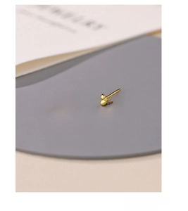 Macro shot of gold-plated S999 sterling silver bow earrings with delicate textures