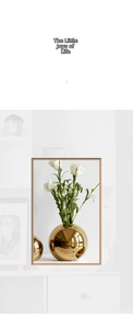 Detail of a spherical gold mirror ceramic vase with elegant white calla lily flowers