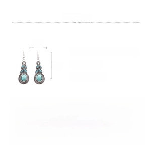 Detail view of retro silver earrings with turquoise inlay and rhinestone accents