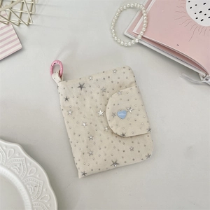 Detail of canvas mini wallet with star sequins, blue heart button and pink carabiner