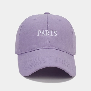 Close-up of white PARIS embroidery on light purple cotton canvas baseball cap