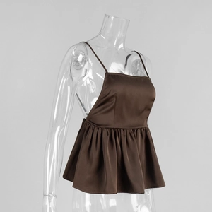 Detail view of brown satin camisole top with ruffle peplum hem and adjustable thin straps