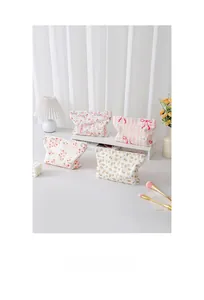 Close-up of four floral quilted cotton makeup bags with elegant metal zipper details
