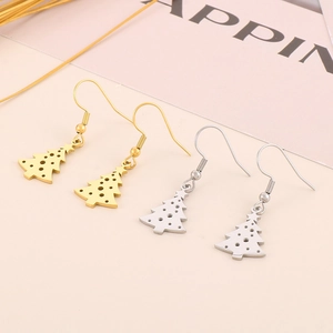 Golden and silver stainless steel Christmas tree earrings set on pink background