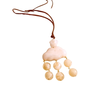 Cloud-shaped resin pendant necklace with light yellow beads and brown cord strap