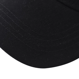 Close-up of black cotton baseball cap brim with precise four-row parallel stitching detail