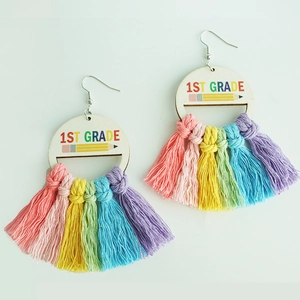 Detail of 1st Grade teacher earrings featuring wooden pencil disk and rainbow tassels