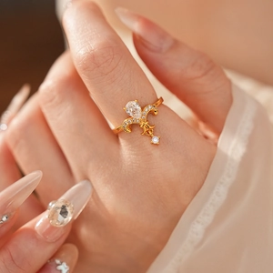 Macro shot of a vintage gold floral ring featuring a pear-cut zircon and pave accents