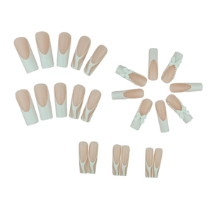 Long white French press-on nails with 3D bows and pearls in a full set display