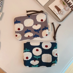Detailed view of floral cotton linen mini pouches with zippers and braided zipper pulls