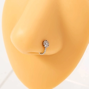Detailed view of a silver flower nose ring with crystals and a twisted rope band