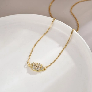 Elegant gold-tone oval peanut necklace with rectangular zircon inlay on white ceramic base