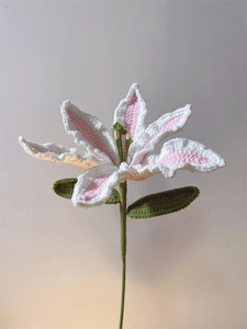 Detailed handmade crochet lily bouquet with delicate pink and white yarn flower petals