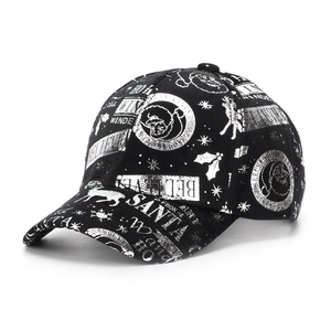 Detailed view of black baseball cap with silver reflective Christmas pattern and text