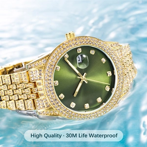 Macro detail of luxury gold watch with emerald dial and crystal-encrusted finish