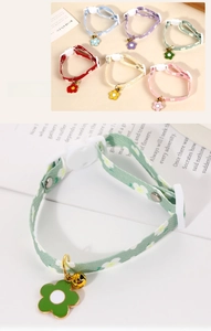 Detail view of colorful floral pet collars with adjustable buckles and sun flower pendants