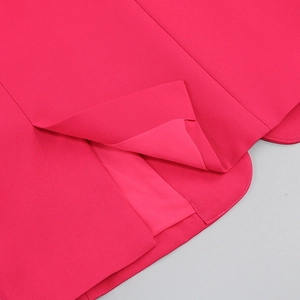 Close-up of fuchsia blazer hem with ostrich feather trim and fine twill texture