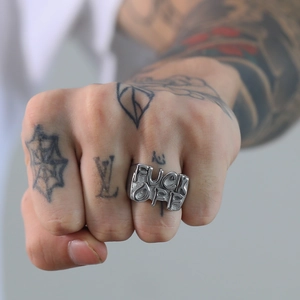 Detailed view of a vintage silver titanium steel ring featuring bold FUCK OFF lettering