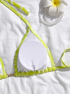 Detail view of neon green striped bikini top with removable pads and soft inner lining