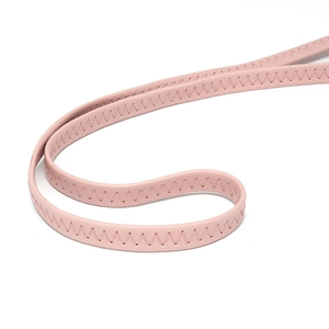 Close-up of pink leather shoulder strap with decorative Z-shaped reinforced stitching