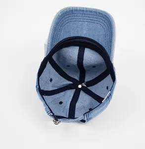 Internal view of the light blue denim baseball cap showing six-panel stitching and metal buckle