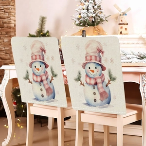 Detailed view of two Christmas chair covers with snowman design in a festive dining room