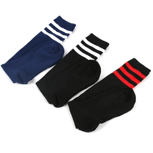 Detailed knit texture of three-stripe calf-high socks in blue, black, and red colors