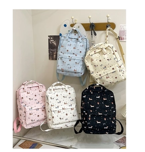 Detail of colorful graffiti dog and bow pattern on canvas backpack with zipper pocket
