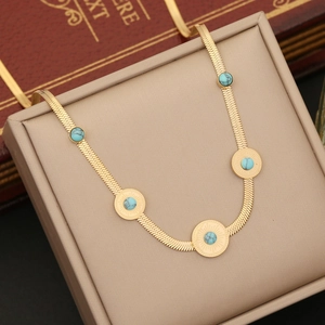 Golden herringbone chain necklace with turquoise sunburst charms in elegant display box