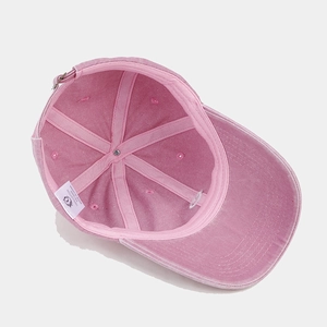 Pink washed cotton baseball cap with heart embroidery shown from an interior view