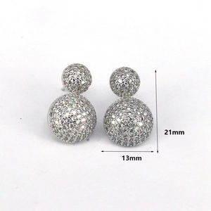 Detail showing 21mm double sphere stud earrings with white zircon micro-paving stones