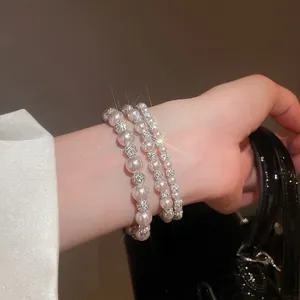 Elegant multi-layer pearl bracelet set with silver diamond-studded pave ball accents